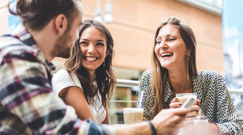 Three people outside a building